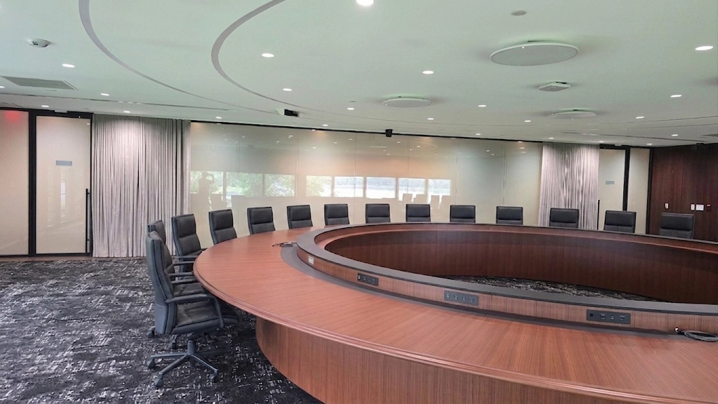 Executive boardroom with custom motorized ripplefold drapery open.