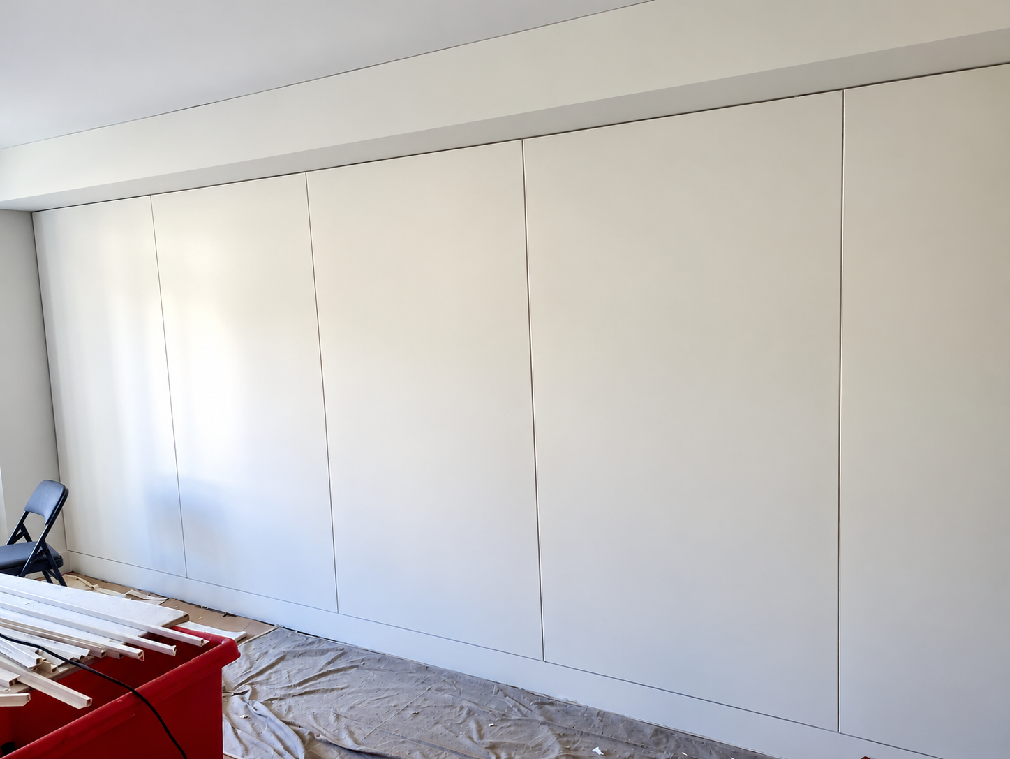 Full wall of custom upholstered panels in a classical New York residential interior, showing panel alignment and scale